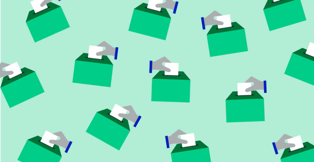 Hands voting in ballot boxes